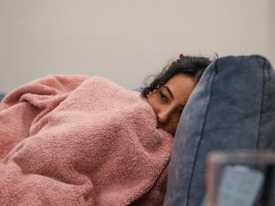 Sick woman under blanket