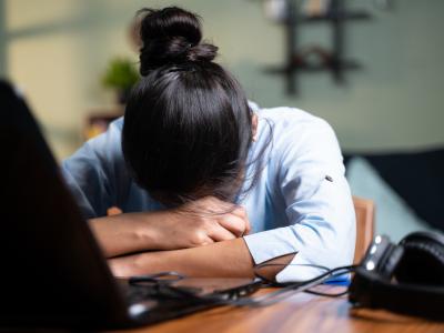 Sleeping Asian woman at desk