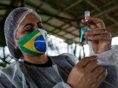 Vax worker filling syringe