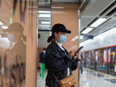 Woman in mask waiting for subway train