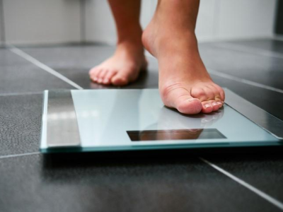 Woman stepping onto scale
