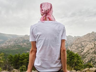 Woman with cancer on rock