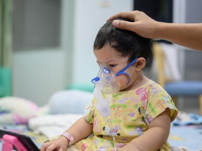 Young girl in oxygen mask