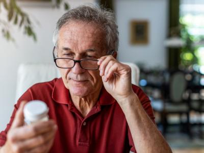 Older man looking at medication