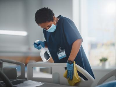 Nurse cleaning hospital bed
