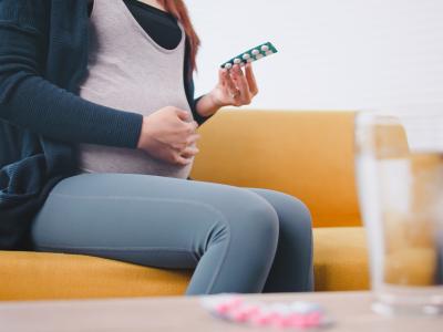 Pregnant women holding pills
