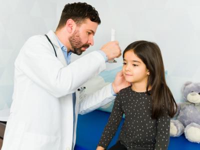 Doctor examining child's ears