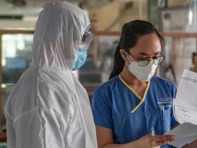 Two healthcare workers wearing personal protective equipment