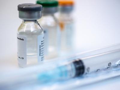 Three vaccine vials and syringe
