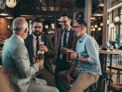 4 men drinking beer in bar