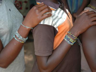 African girls with hands on one another's shoulders