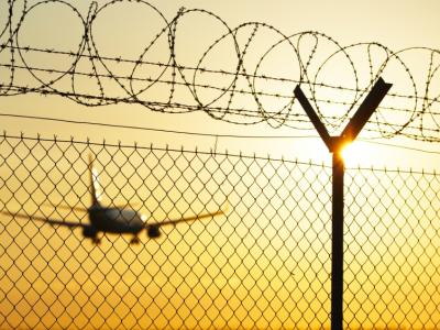 Airplane behind fence