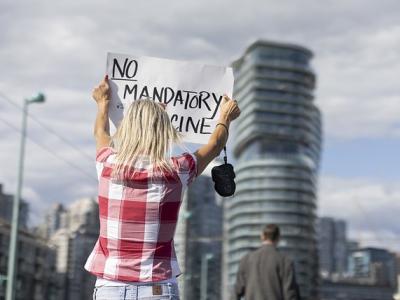 Anti-vaccine protester with sign