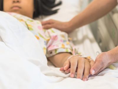 Asian girl in hospital bed