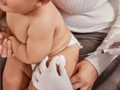 Baby getting vaccinated on mom's lap