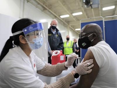 Bald man getting COVID vaccine