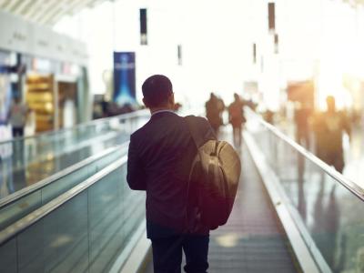 Businessman on airport moving sidewalk