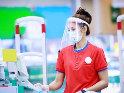 Cashier with mask and face shield