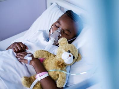 Childe with oxygen mask and teddy bear