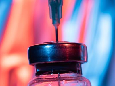 Close-up of needle inserted into vial