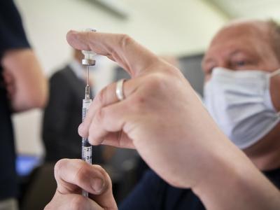 Vaccinator with syringe in foreground