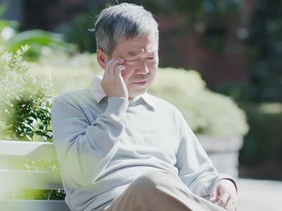 Confused older man on park bench