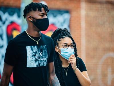 Man and woman wearing masks