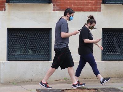 Couple wearing masks walking on street