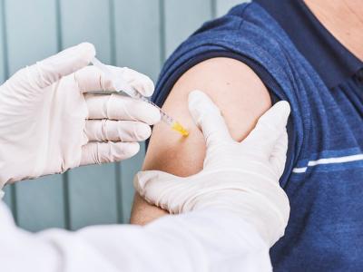 COVID vaccine going into man's arm