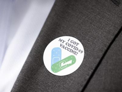 COVID vaccine sticker on lapel