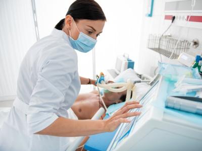 Doctor wearing surgical mask at bedside
