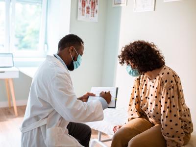 Doctor with patient, both wearing masks