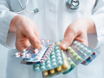 Doctor with packs of pills
