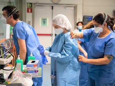 Hospital workers donning PPE