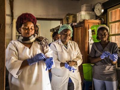 Healthcare workers donning gloves