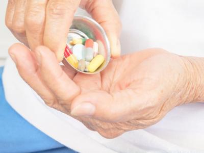 Drugs in hand of older woman