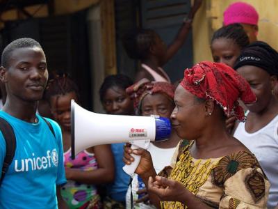 Worker using megaphone to educate in Guinea