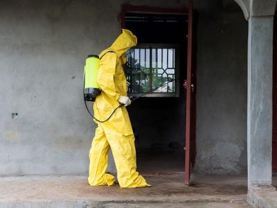 Ebola worker disinfecting