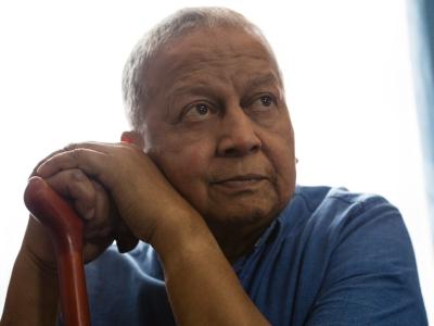 Elderly man leaning on cane