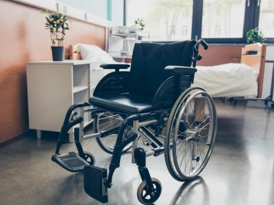 Empty wheelchair and hospital bed
