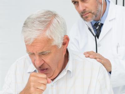 Examining coughing senior