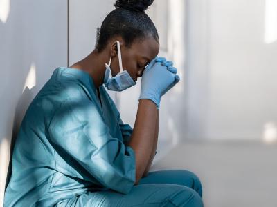 Exhausted nurse in hallway