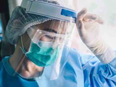 Exhausted nurse in full PPE
