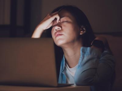 Exhausted woman at computer