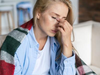 Exhausted woman draped in blanket
