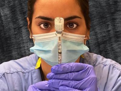 Pharmacist dosing the Pfizer COVID vaccine