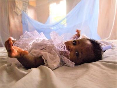 Baby under mosquito bed net