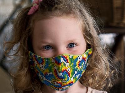 Girl wearing colorful mask