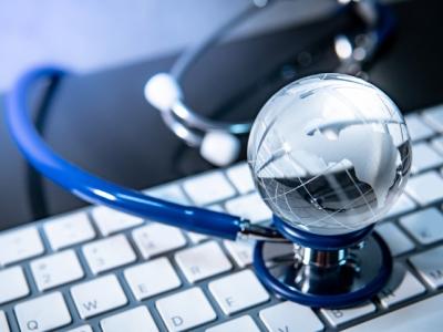 Globe and stethoscope on keyboard