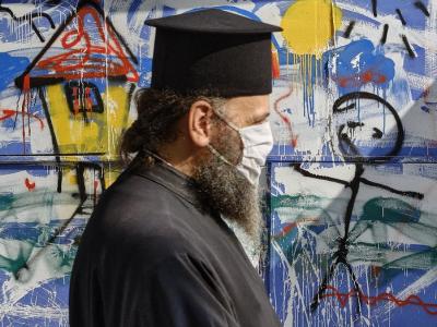 Greek Orthodox priest wearing mask in Athens